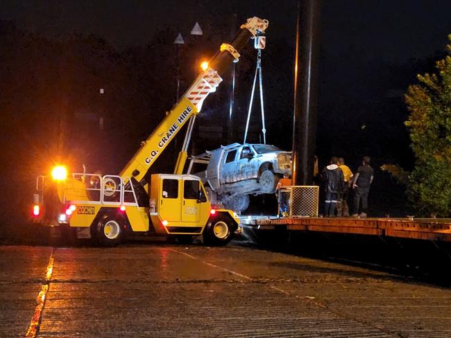 CQ Crane Hire lifting the stolen $350,000 Ford F350 ute over the jetty at the Quay Street boat ramp after it was winched out of the crocodile infested Fitzroy River in an eight-hour salvage operation on July 4, 2023. The ute belonged to Stewart Gander from Benalla, Victoria. It had been stolen from a Yeppoon caravan park just after midnight on July 2, 2023.