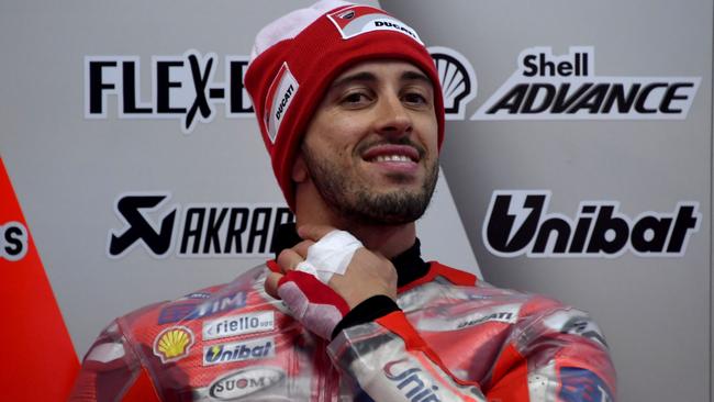 Ducati rider Andrea Dovizioso of Italy smile in his pit prior to the first practice round of the MotoGP Japanese Grand Prix at Twin Ring Motegi circuit in Motegi, Tochigi prefecture on October 13, 2017. / AFP PHOTO / Toshifumi KITAMURA