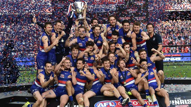 Bulldogs players pose with the premiership cup.