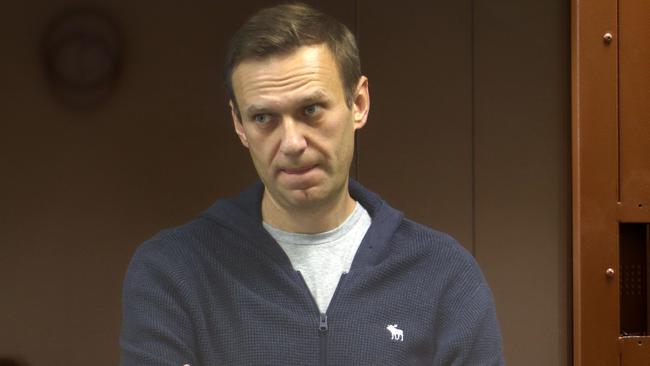 Russian opposition leader Alexei Navalny, charged with defaming a World War II veteran, standing inside a glass cell during a court hearing in Moscow. Picture: AFP.