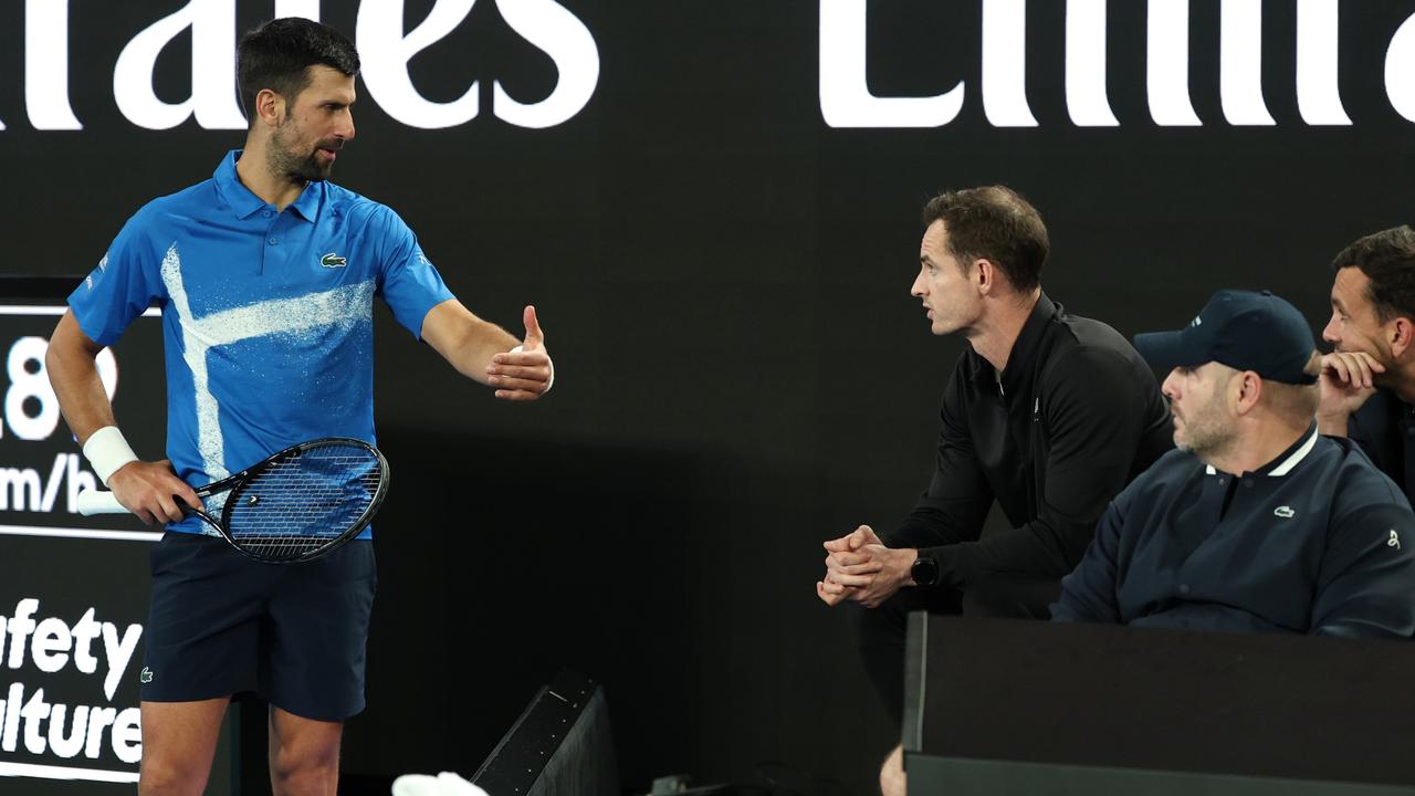 MELBOURNE, AUSTRALIA - JANUARY 13: Novak Djokovic of Serbia speaks with his coach, Andy Murray, against Nishesh Basavareddy of the United States in the Men's Singles First Round match during day two of the 2025 Australian Open at Melbourne Park on January 13, 2025 in Melbourne, Australia. (Photo by Cameron Spencer/Getty Images)