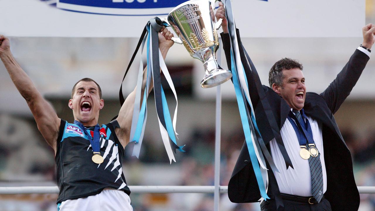 Warren Tredrea and Mark Williams holding up the 2004 premiership cup.