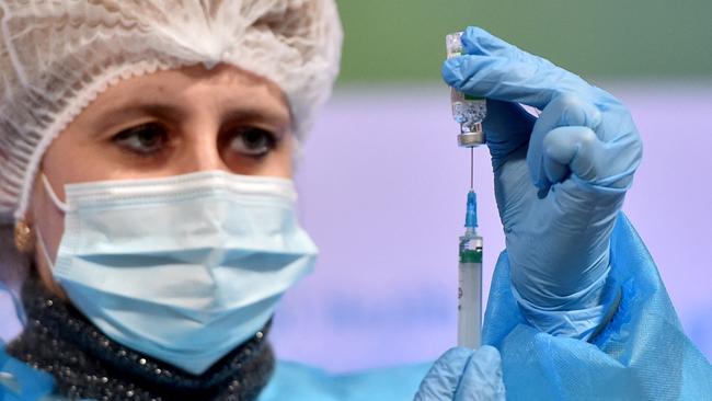 A medical worker draws up a dose of the Oxford/AstraZeneca vaccine.