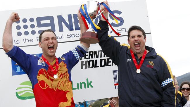 Mulgrave’s Hayden Stanton and Brad Fowler raise the drought-breaking Division 2 premiership cup in 2010.