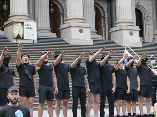 MELBOURNE, AUSTRALIA - NewsWire Photos, MARCH 18, 2023. Protest groups face off in front of the Victorian Parliament where UK far right activist Kellie-Jay Keen is due to speak. Far right wing group does Nazi salutes on the steps of  of Parliament. Picture: NCA NewsWire / David Crosling