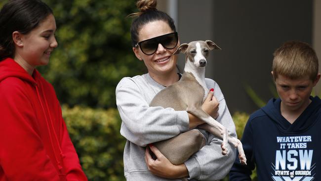 Owner Kyley Bugeja cuddles Vic with daughter Bella and son Levi after their pet was found. Picture: NCA NewsWire / Daniel Pockett