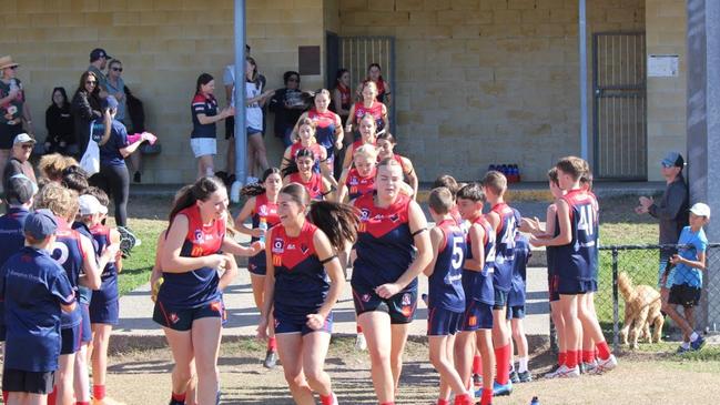 The Surfers Paradise Demons burst onto the field.