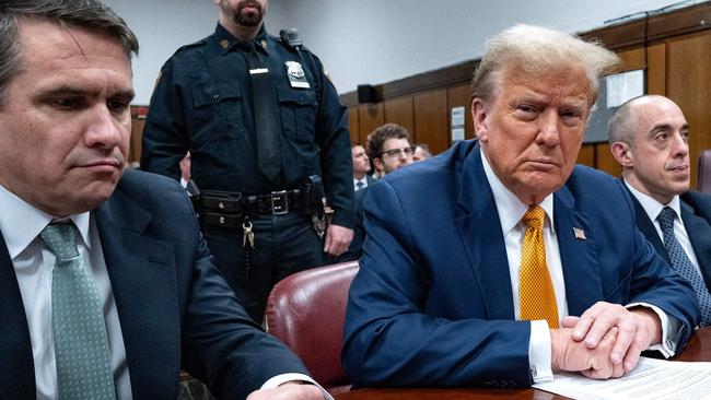 Former US President Donald Trump, with lawyers Todd Blanche (L) and Emil Bove (R), attends his trial for allegedly covering up hush money payments. (Photo by Craig Ruttle / POOL / AFP)