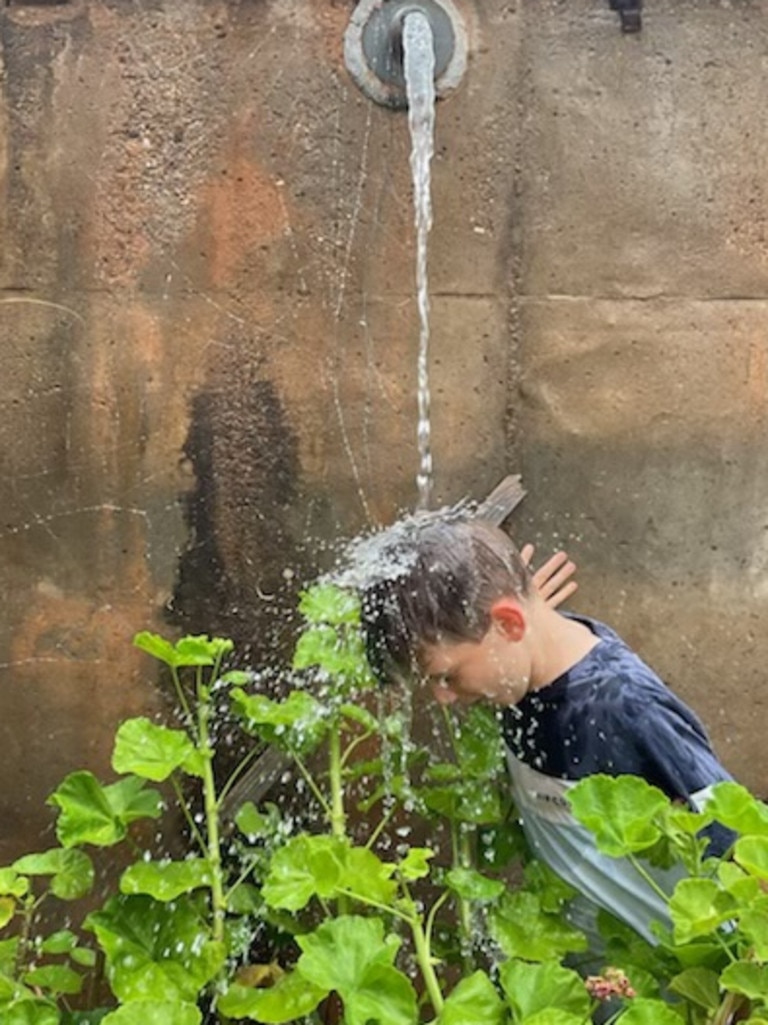 Leigh Fitzgerald’s property at Emu Rocks had 300mm of rain over the weekend – young Flynn got a bit wet. Supplied: Leigh Fitzgerald ,