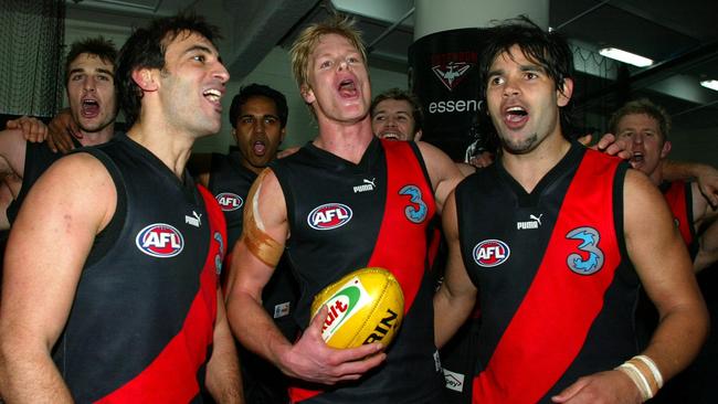 Richard Cole (right) sings the Bombers’ song with Scott Camporeale and Adam McPhee.