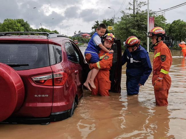 Rescuers help residents in a flooded area after Typhoon Doksuri made landfall in Quanzhou, China. Picture: CN/AFP