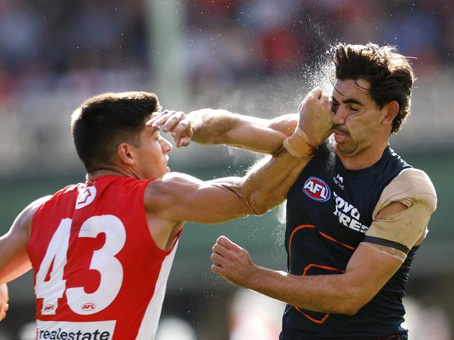 Giant Toby Bedford is collected by Sydney's Lewis Melican. Picture: Phil Hillyard.