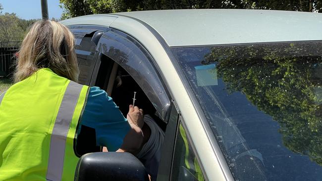 Getting their drive-through Pfizer jab at the Gold Coast on Tuesday were two NRL footy players from the Parramatta Eels, Isaiah Papali’i, 23 and Hayze Perham, 22. Photo: Emily Toxward