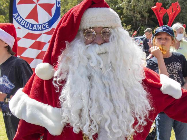 SYDNEY AUSTRALIA - NewsWire Photos, 16 DECEMBER, 2022: Premier Dominic Perrottet  greets Santa arriving at Bear Cottage children's hospice with gifts for children and families. Santa pictured with Kamahl Sadi.Picture: NCA NewsWire/ Simon Bullard.