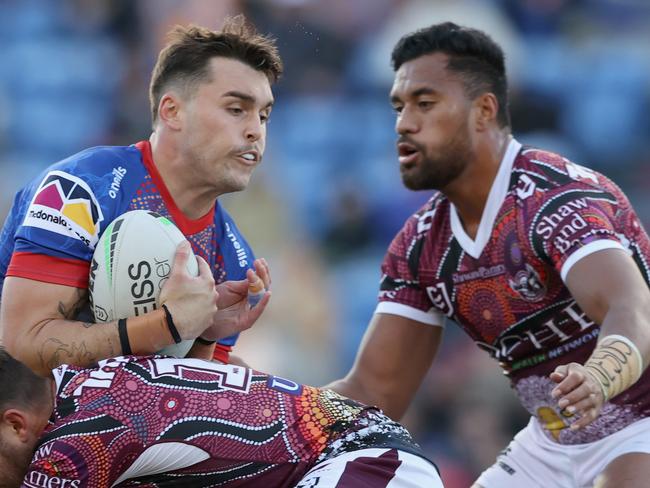 NEWCASTLE, AUSTRALIA - MAY 30: Tex Hoy of the Knights is tackled during the round 12 NRL match between the Newcastle Knights and the Manly Sea Eagles at McDonald Jones Stadium, on May 30, 2021, in Newcastle, Australia. (Photo by Ashley Feder/Getty Images)