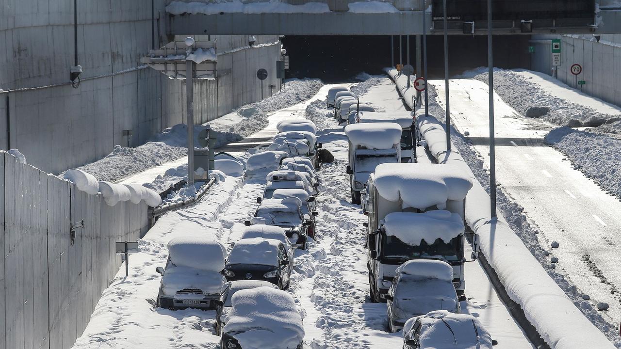 Cars abandoned after being snowed in on an Athens highway. Picture: Sotiris Dimitropoulos/Eurokinissi/AFP​