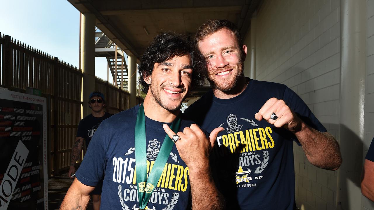 Gavin Cooper (right) with Johnathan Thurston after the Cowboys’ maiden premiership in 2015. Picture: Zak Simmonds