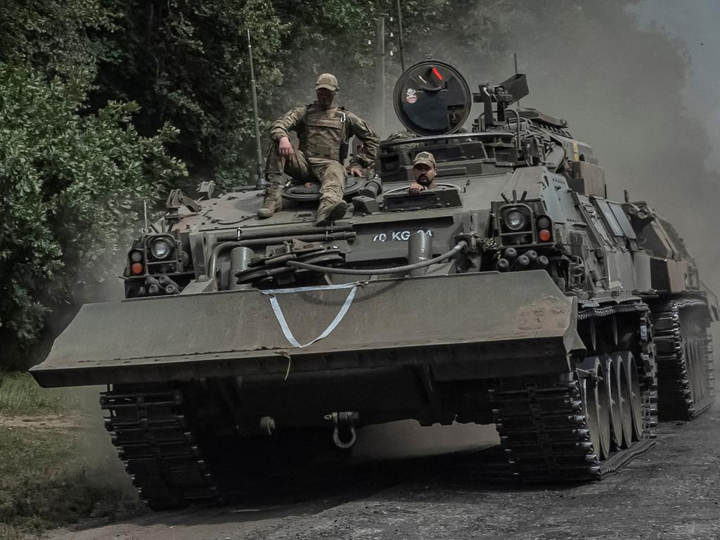 FILE PHOTO: Ukrainian servicemen ride a military vehicle, amid Russia's attack on Ukraine, near the Russian border in Sumy region, Ukraine August 10, 2024. REUTERS/Viacheslav Ratynskyi/File Photo