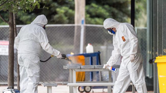 Workers clean surfaces at Kensington Primary School today. Picture: Jake Nowakowski