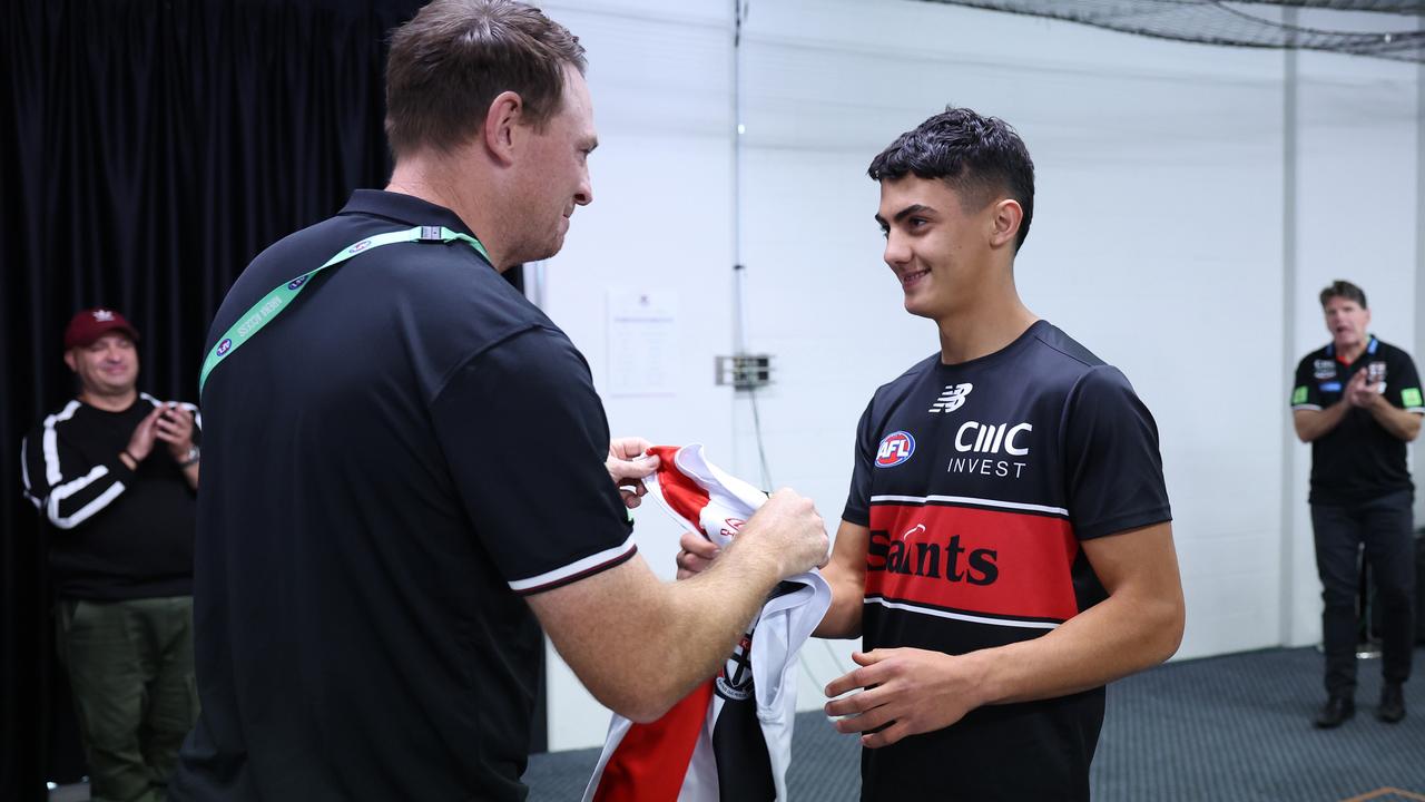 Hugo Garcia receives his jumper on debut from Brendon Goddard. Picture: Mark Metcalfe/AFL Photos/Getty Images