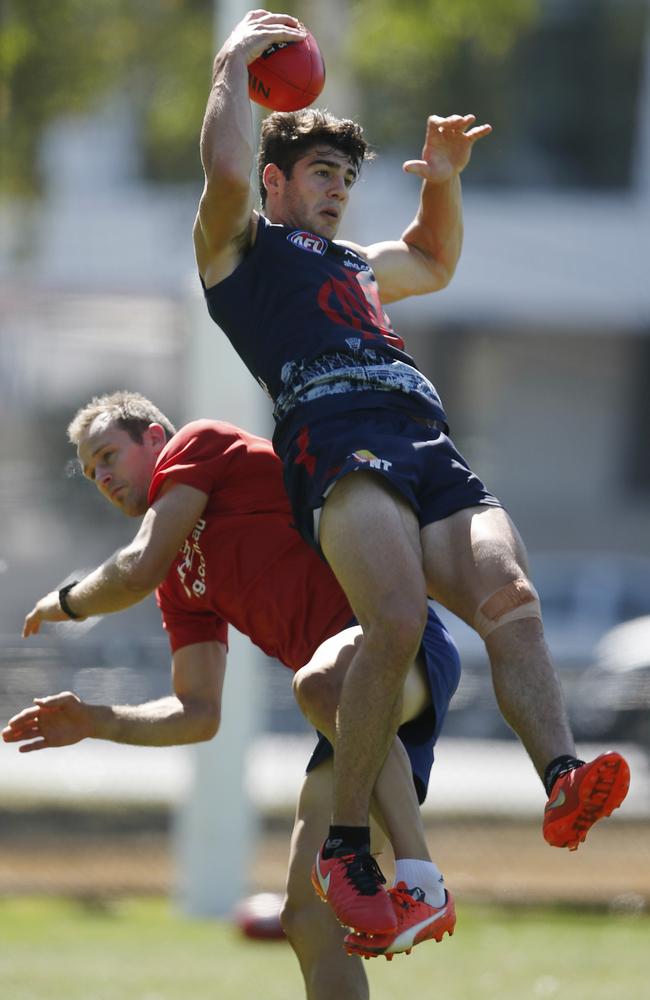 Christian Petracca marks over Daniel Cross. Picture: Michael Klein