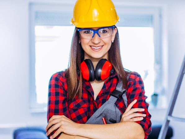 TAFE story: Beautiful brunete woman manual worker with tools indoors.