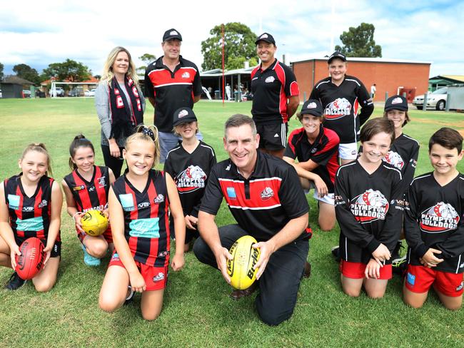 Junior Football Director at Plympton Football club, Jamie Morgan, (C) with club volunteers,(back LtoR) Fiona and Pat Lambert and Craig Bennetts, and Junior footballers (LtoR) Ella Winstanley,13, Ava Lambert,10, Lucy Winstanley,11, Jarrad Lambert,12, Liam Bennetts,14, Noah Bennetts,11, Jack Winstanley,14, Harvey Lambert,14, and Angus Morgan, 9.At Plympton Park, 24 February 2018. (AAP Image/Dean Martin)