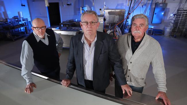 Ian Cook (centre) with retired detective Sergeant Paul Brady and retired detective Inspector Rod Porter (right). Picture: Alex Coppel