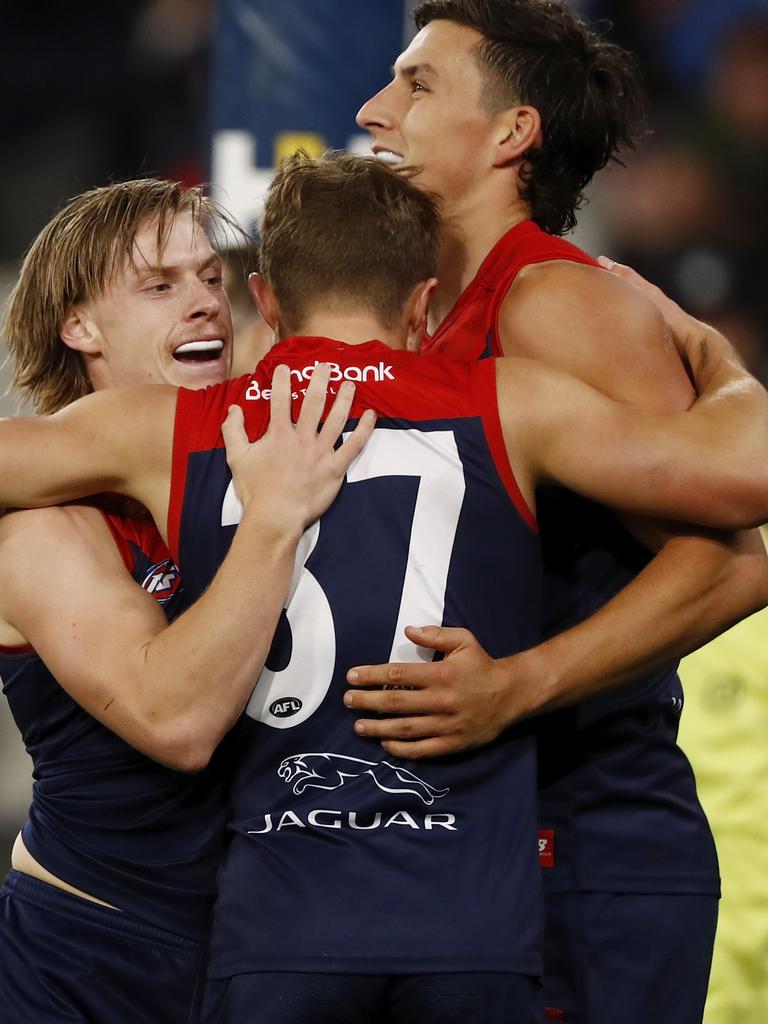 Charlie Spargo celebrates a goal with Kade Chandler and Sam Weideman.