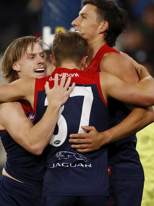 Charlie Spargo celebrates a goal with Kade Chandler and Sam Weideman.