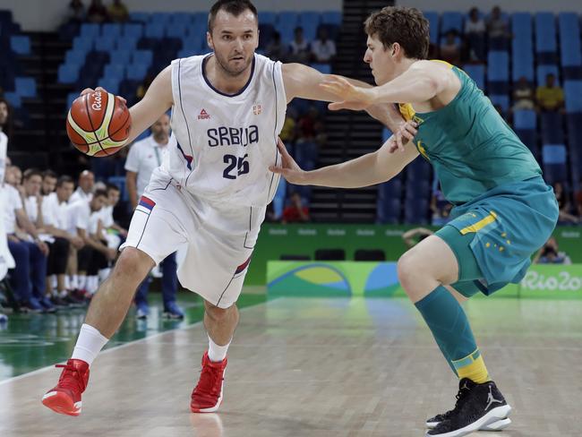 Milan Macvan drives past 's Cameron Bairstow during the group stage match.