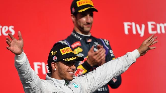 Lewis Hamilton of  Mercedes GP celebrates on the podium next to Daniel Ricciardo of Infiniti Red Bull Racing following his victory in the US Grand Prix.