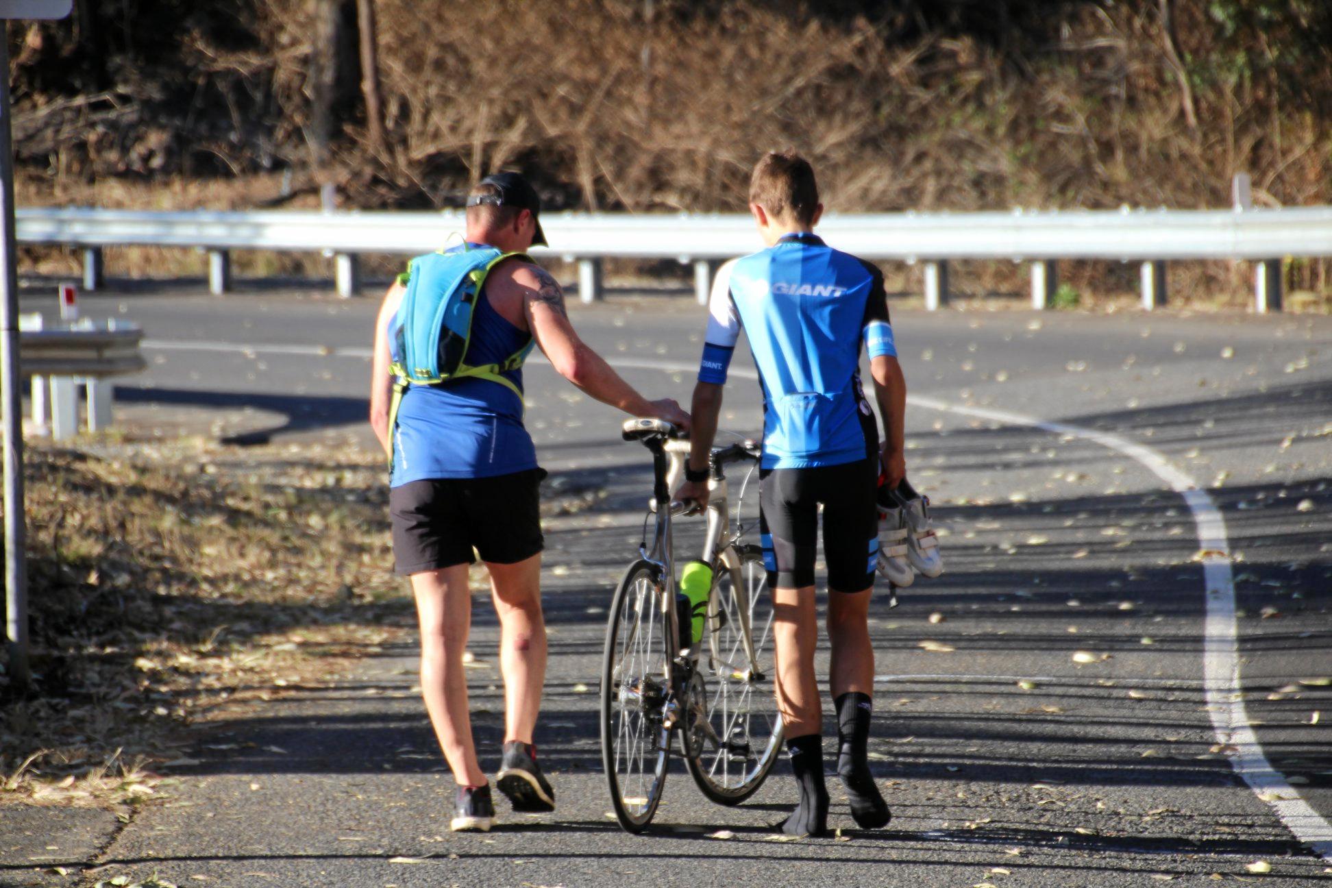 Runner Lee Pratt stops to help a cyclist finish Challenge the Mountain. Picture: Rockhampton Photography Club