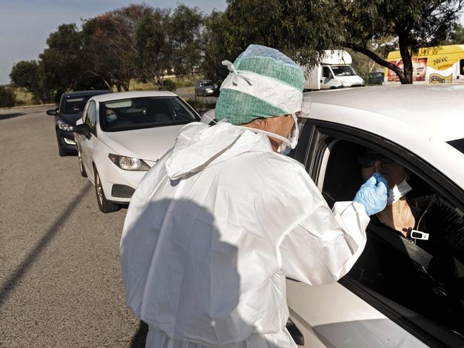 A health worker uses a swab to test a driver. Picture: AFP