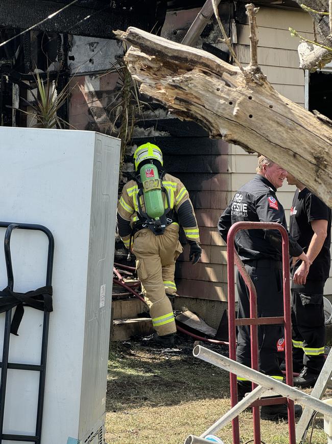 Firefighters put out a secondary blaze within the charred remains of the Merrylands home. Picture: Amaani Siddeek