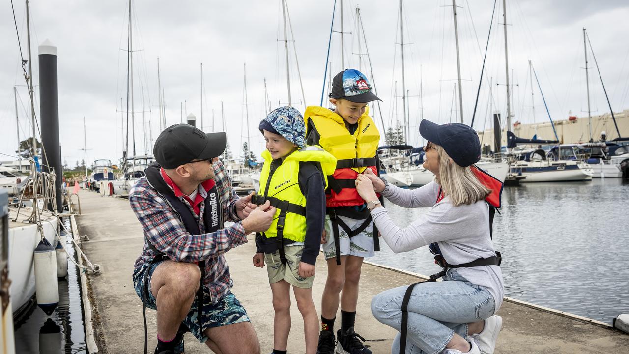 A young family get ready to head out on the water in a boat.