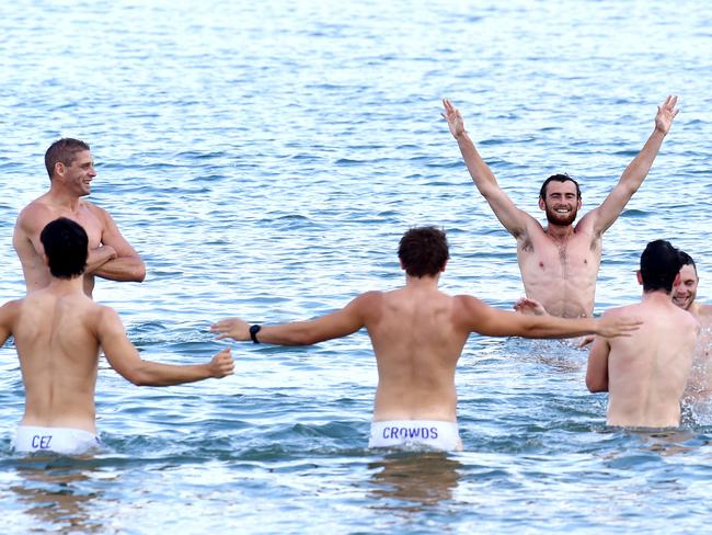 Fremantle Dockers have a dip in Port Phillip Bay yesterday ahead of today’s clash with Richmond. Ross Lyon was nowhere to be seen. Picture: Nicole Garmston