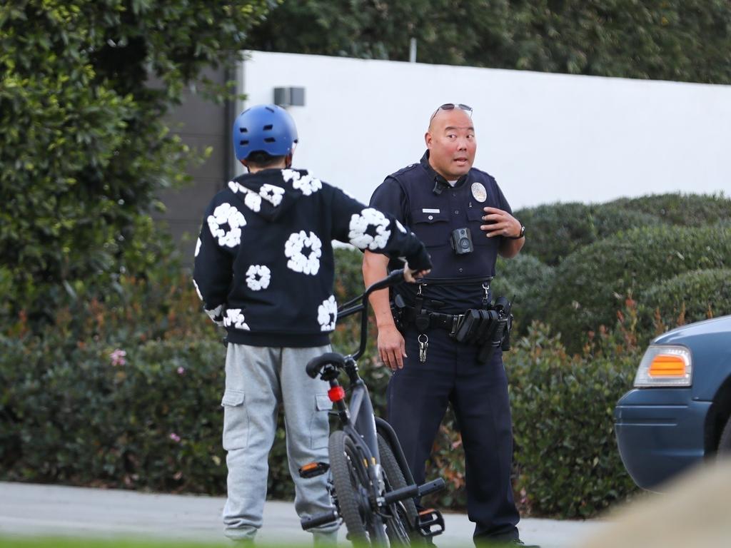 For the second day in a row, police were seen outside Ben Affleck’s home. The star’s son, Samuel, arrived by bike from his mother Jennifer Garner’s house to pick up some clothes. Picture: BACKGRID Australia