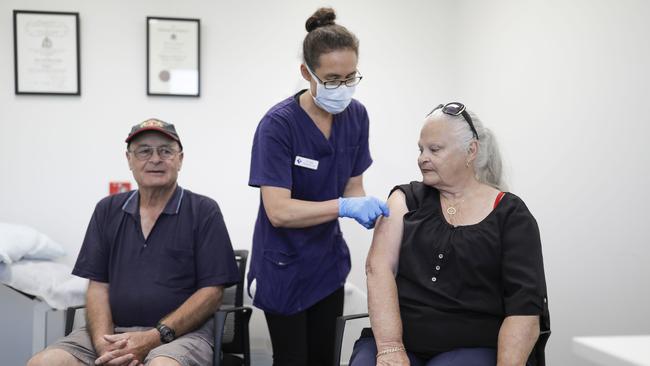 Mallacoota GP Sara Renwick-Lau gives patients Bob Mitchell, 73, and Nola Spiers Mitchell, 77, a flu jab. Picture: Sean Davey