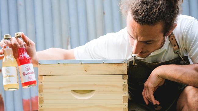 Giacomo Franceschi, pictured alongside a bee hive.