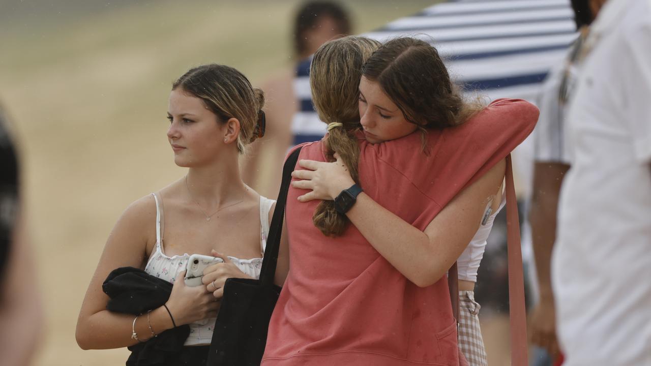 Family and friends of 16-year-old alleged stabbing victim Balin Stewart gather to pay tribute on his home beach at Buddina. Picture: Lachie Millard