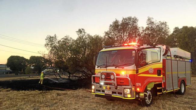 Fire fighters on the scene of a small bush blaze on Wyndham St, Roma. Picture: Alexia Austin