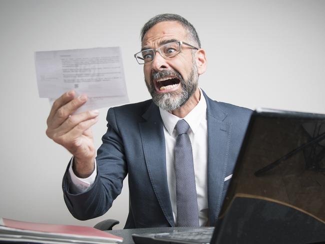 Furious business man shocked and angry with expensive bills he receives at his office, electricity money generic