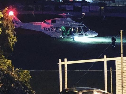 The NSW Ambulance rescue helicopter lands on Manly Oval after winching an injured rock angler who broke his leg after falling at Bluefish Point.