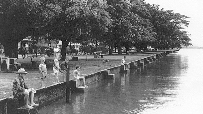 Children fishing at high tide on the Cairns Esplanade seawall, 1964. COURTESY OF CAIRNS HISTORICAL SOCIETY.