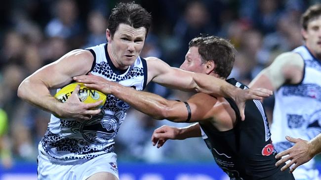 Patrick Dangerfield fends off Brad Ebert.