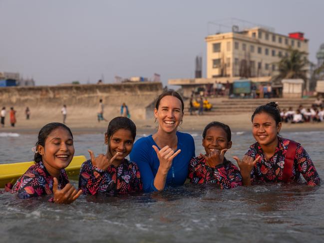 Olympian Emma McKeon, middle, with Beby Kulsum (far left), Jeyasmin, 12, Kayes, 11, and Shobe Maheraz (far right). Picture: Jason Edwards