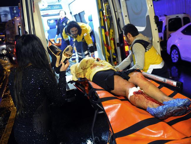 Medics carried a wounded person at the scene after the attack. Picture: IHA via AP