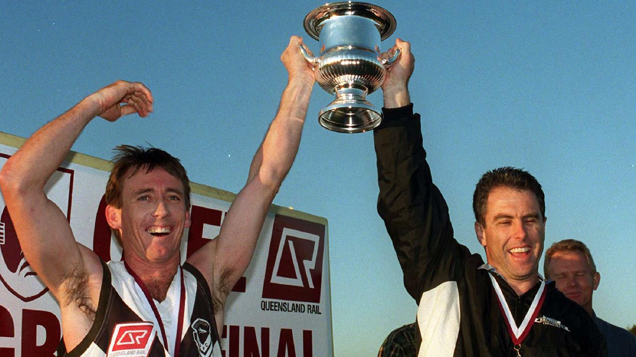 Southport Aussie rules captain David Bain and coach Jason Cotter celebrate after winning the 1999 grand final.