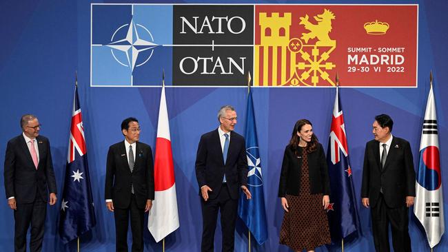 From left: Prime Minister Anthony Albanese, Japan's Prime Minister Fumio Kishida, NATO Secretary General Jens Stoltenberg, New Zealand Prime Minister Jacinda Ardern and South Korea's President Yoon Suk-yeol pose for a group photograph ahead of a Indo-Pacific Partners meeting during the NATO summit.